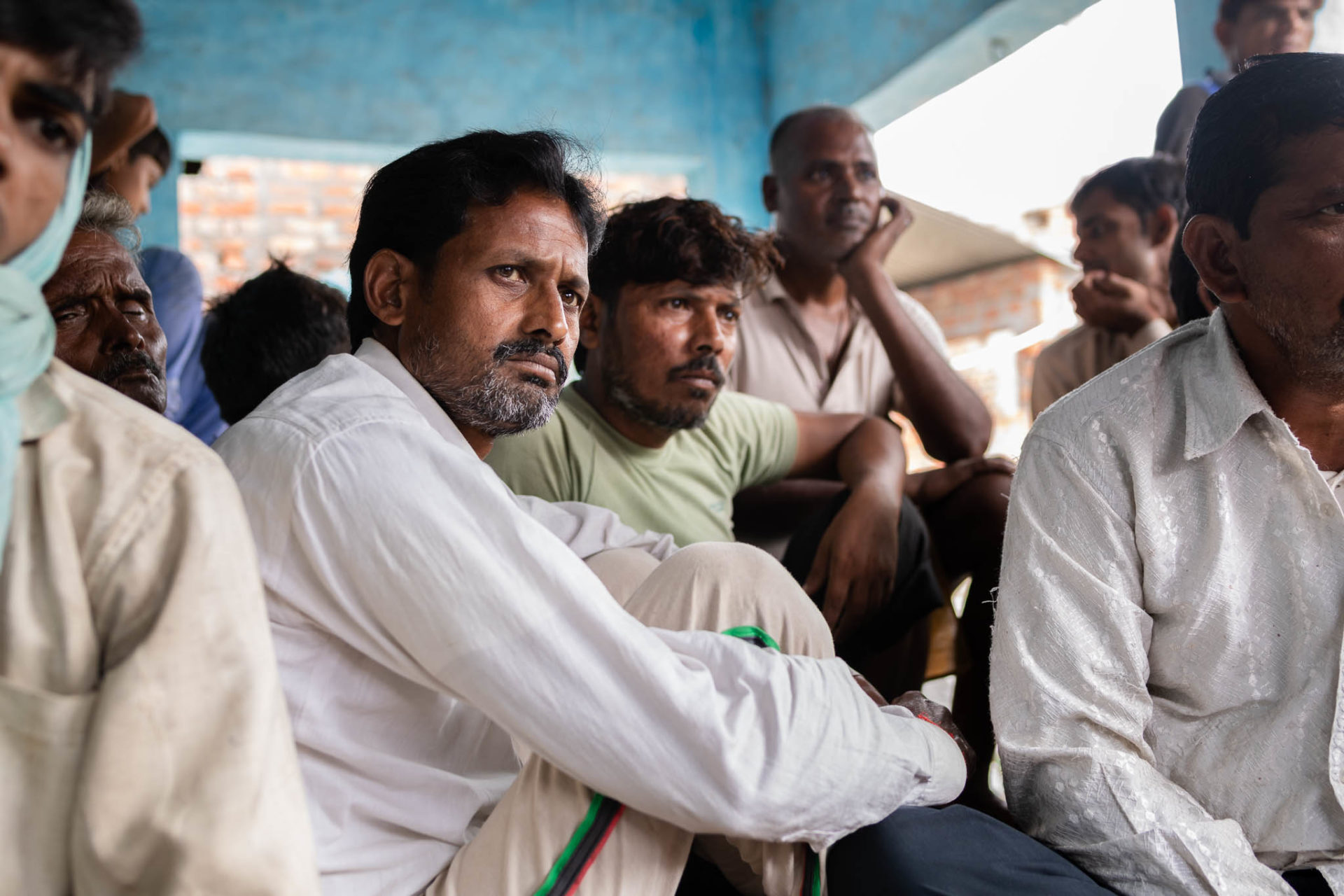 Villagers from the dalit community in Basai Babas listening in a